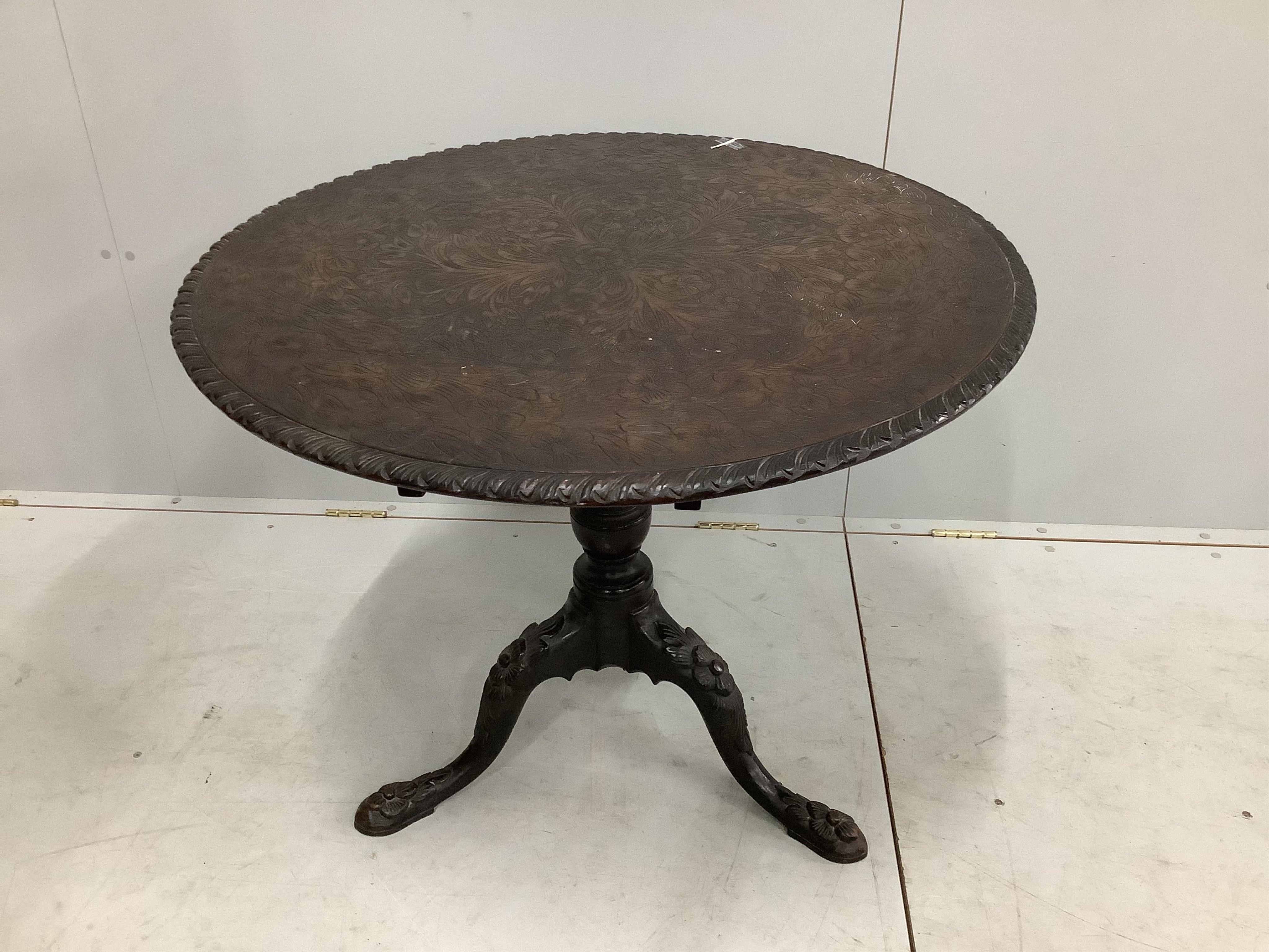 A George III circular mahogany tilt top tea table, later carved, diameter 87cm, height 72cm